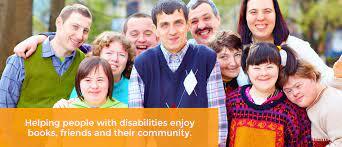 group of adults with developmental disabilities smiling at camera