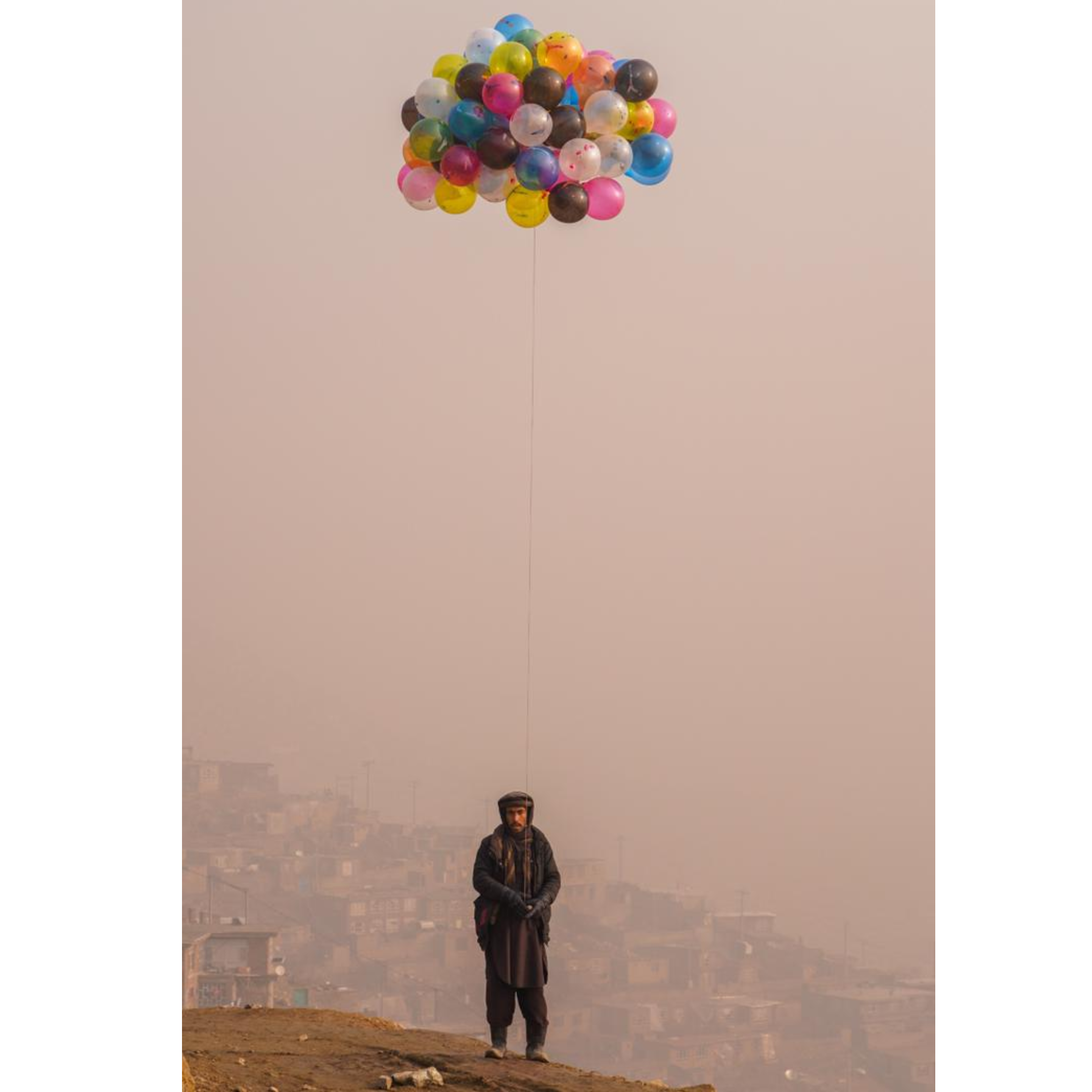 image of man holding balloons