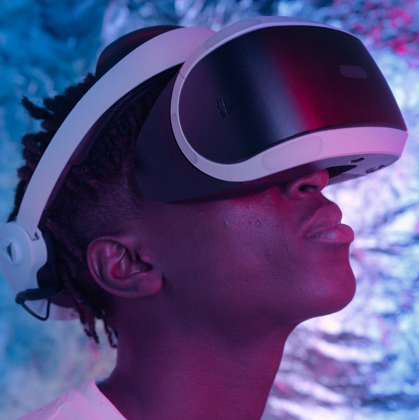 teenage person wearing virtual reality gamming goggles