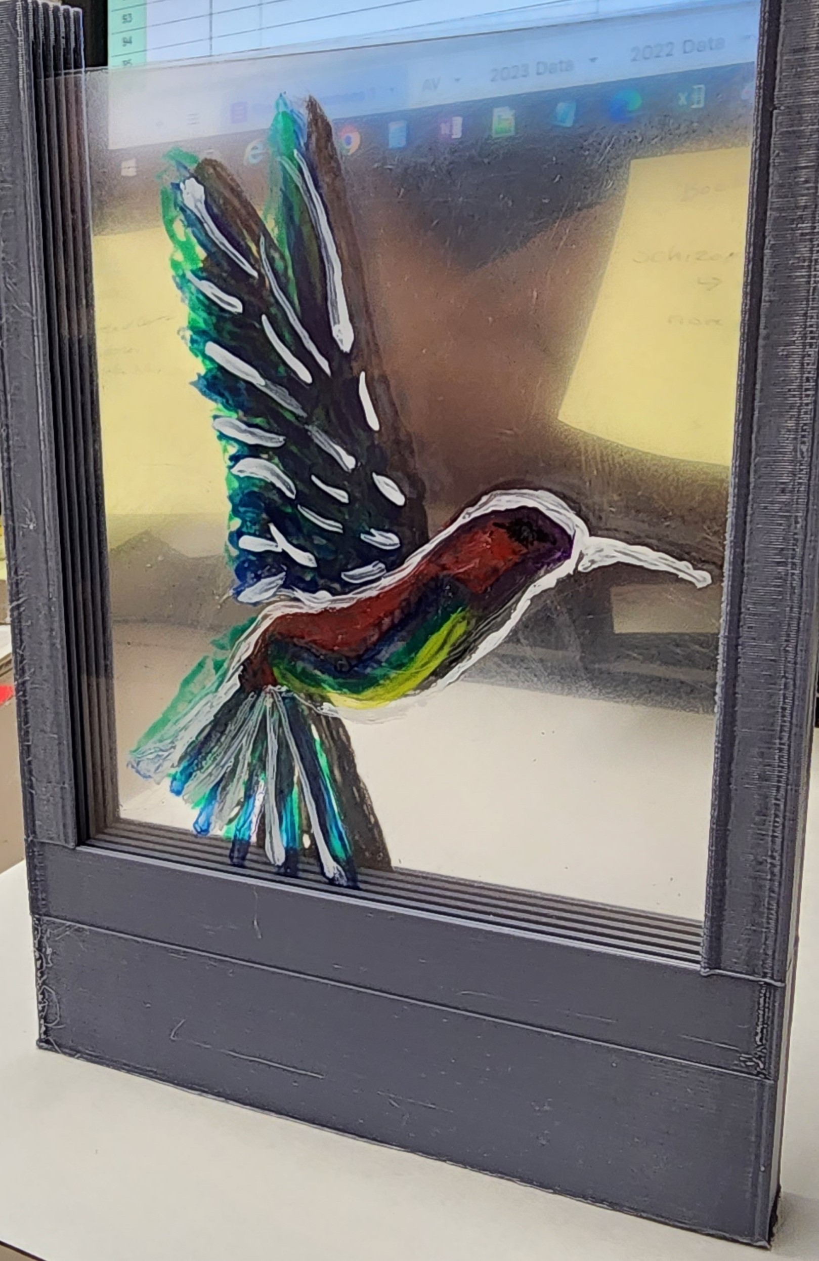 layered painting of a hummingbird. The layers make it look three dimensional
