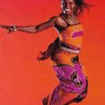 Teresa Smith dancing against a burnt orange background