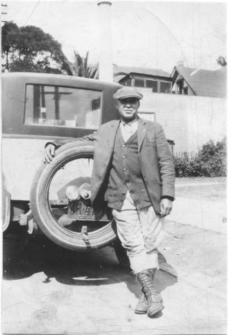Charles Tapsico in Oceanside portrait next to a car early 1900s