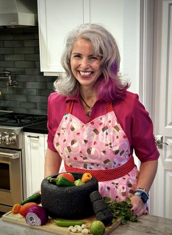 Mole Mama in her kitchen with a molcajete