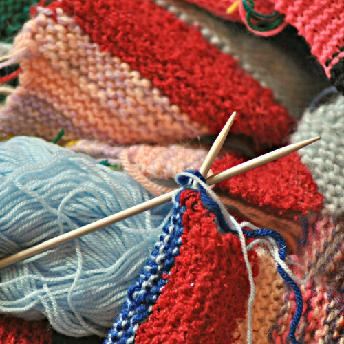 crochet hooks and colorful knitted yarn