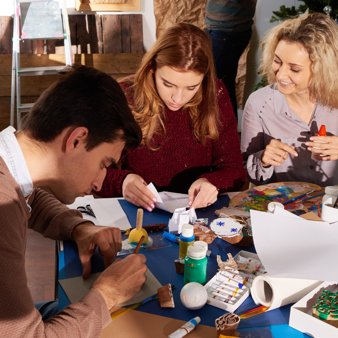 three adults crafting