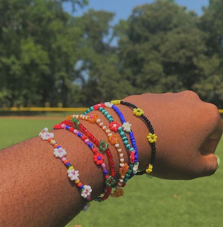 arm with a wrist full of colorful bracelets 