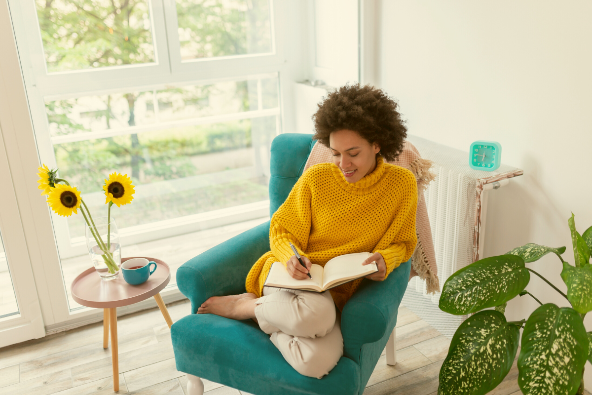 person sitting in chair writing