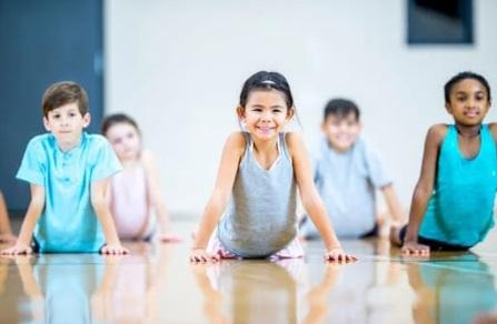 Five kids in a yoga pose