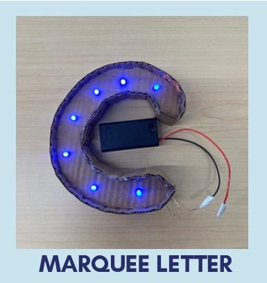 Blue cardboard letter C with lights attached inside